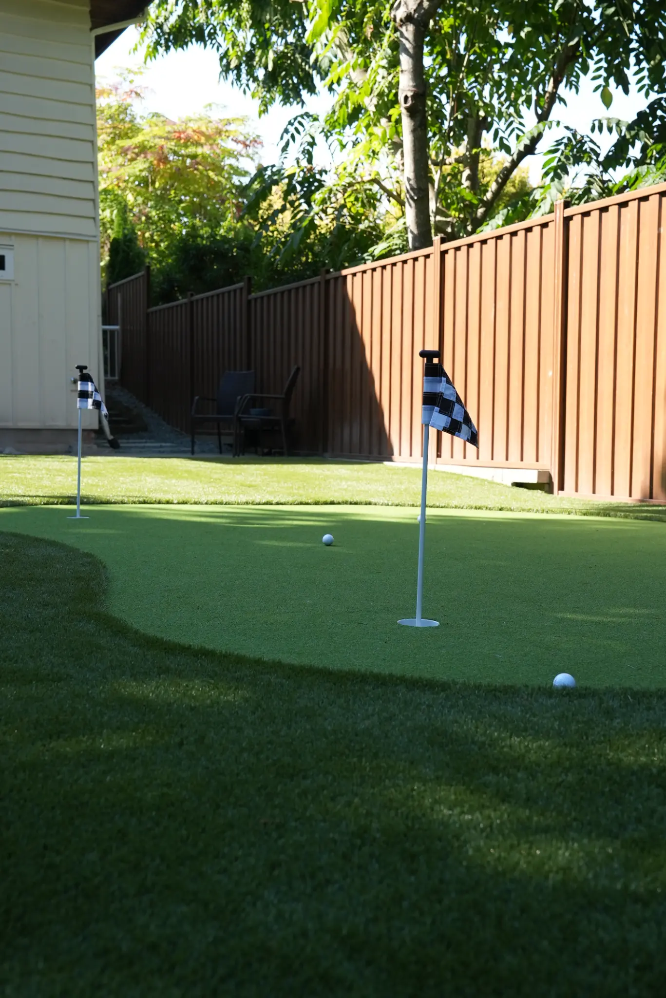 Ground-level view across the putting green with practice flags