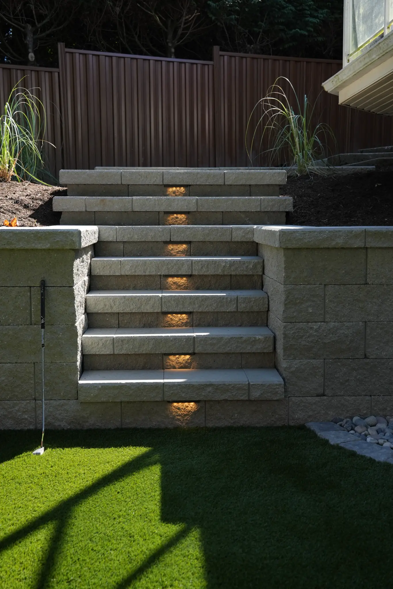 Illuminated retaining-wall stairs leading to the upper garden