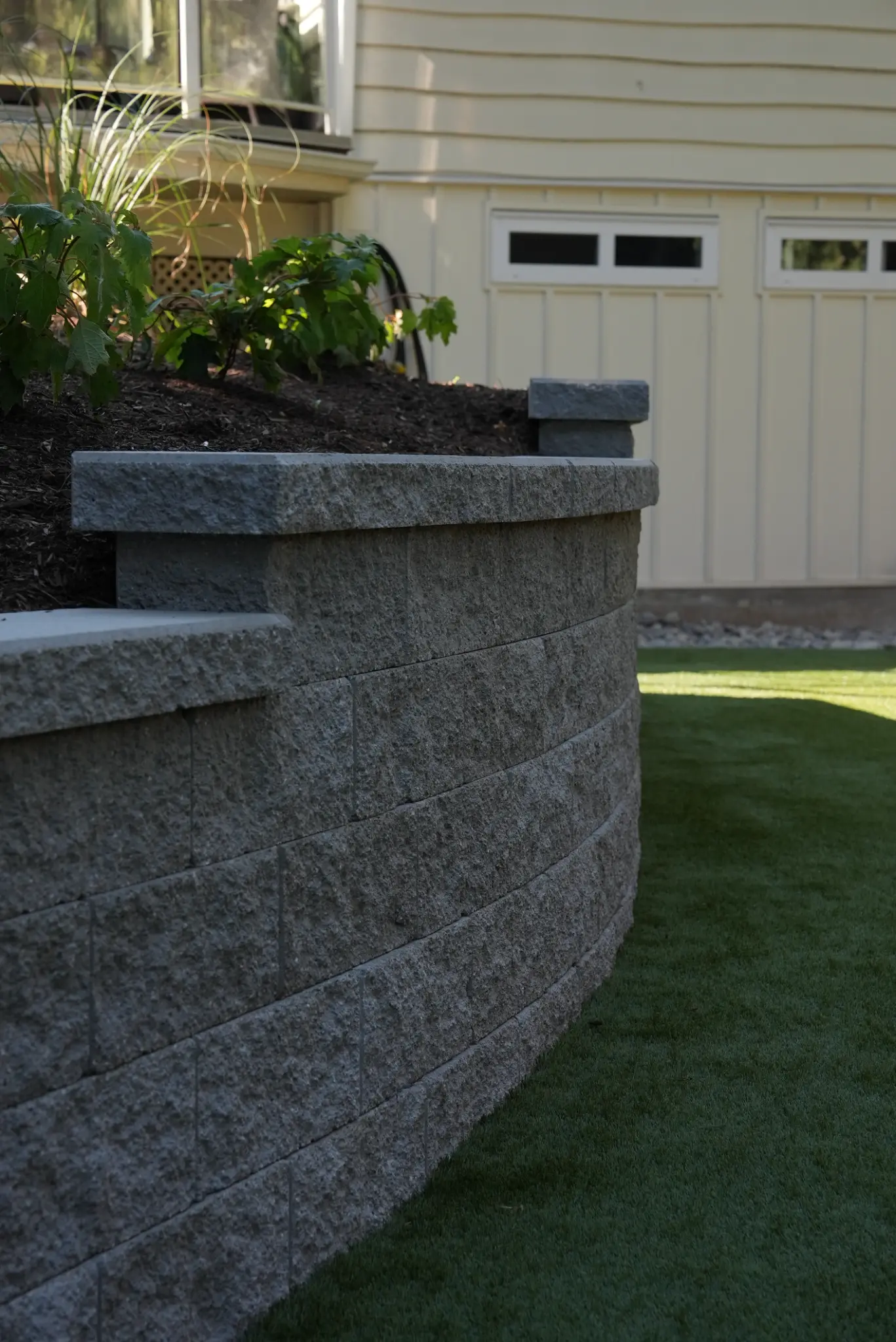 Detailed view of the capped retaining wall and planted garden above