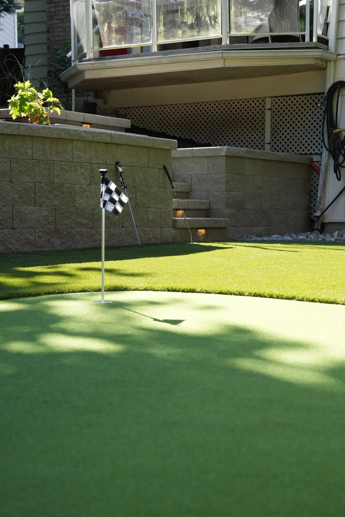 Ground-level view of the putting green with multiple practice holes