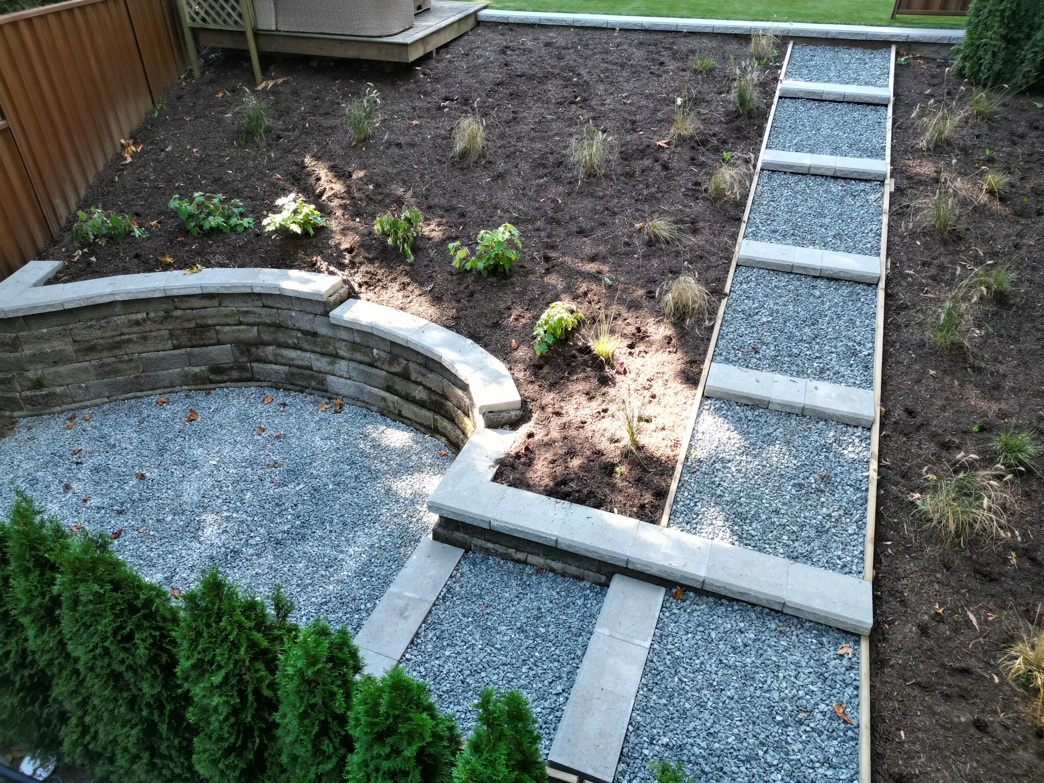 Aerial view of the gravel path, curved wall, and newly planted upper garden
