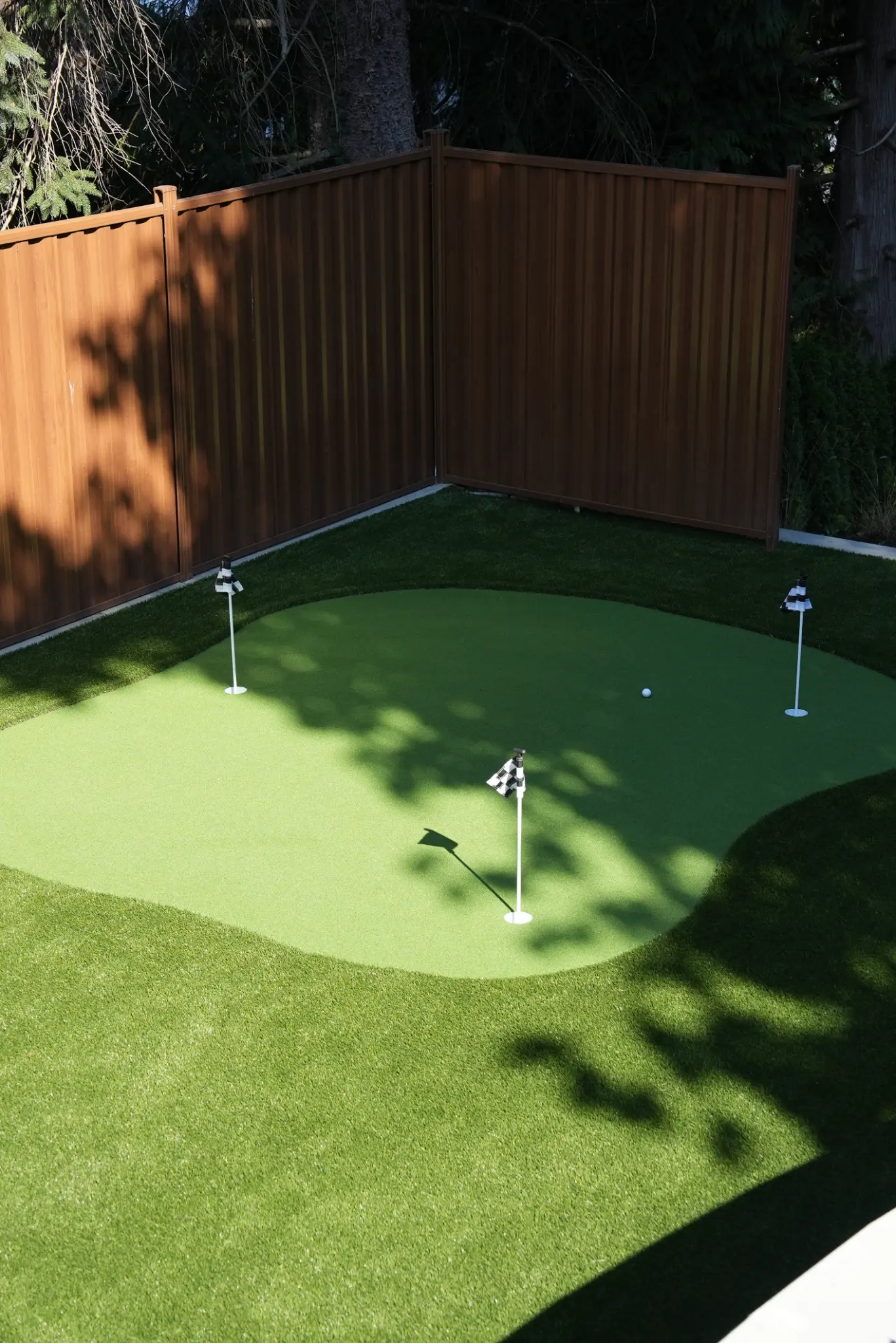 Close-up of the custom putting green with three practice flags