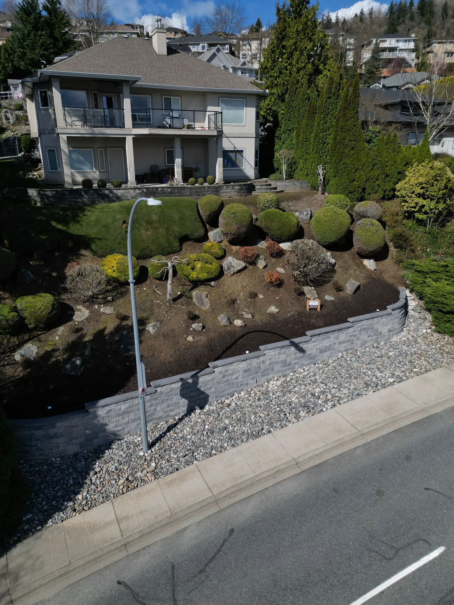 Aerial view of property with retaining wall and fencing