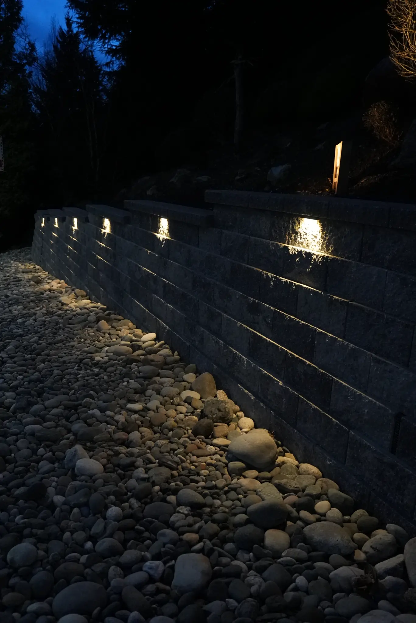 Night view of retaining wall with landscape lighting