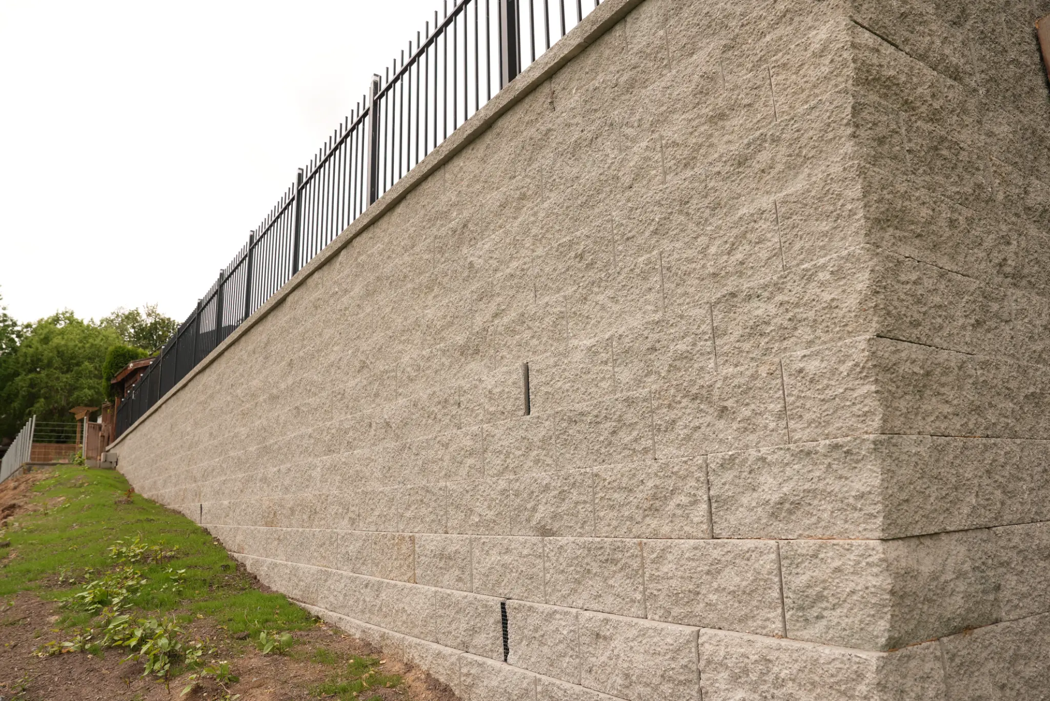 Wall face close-up showing block texture and iron railing