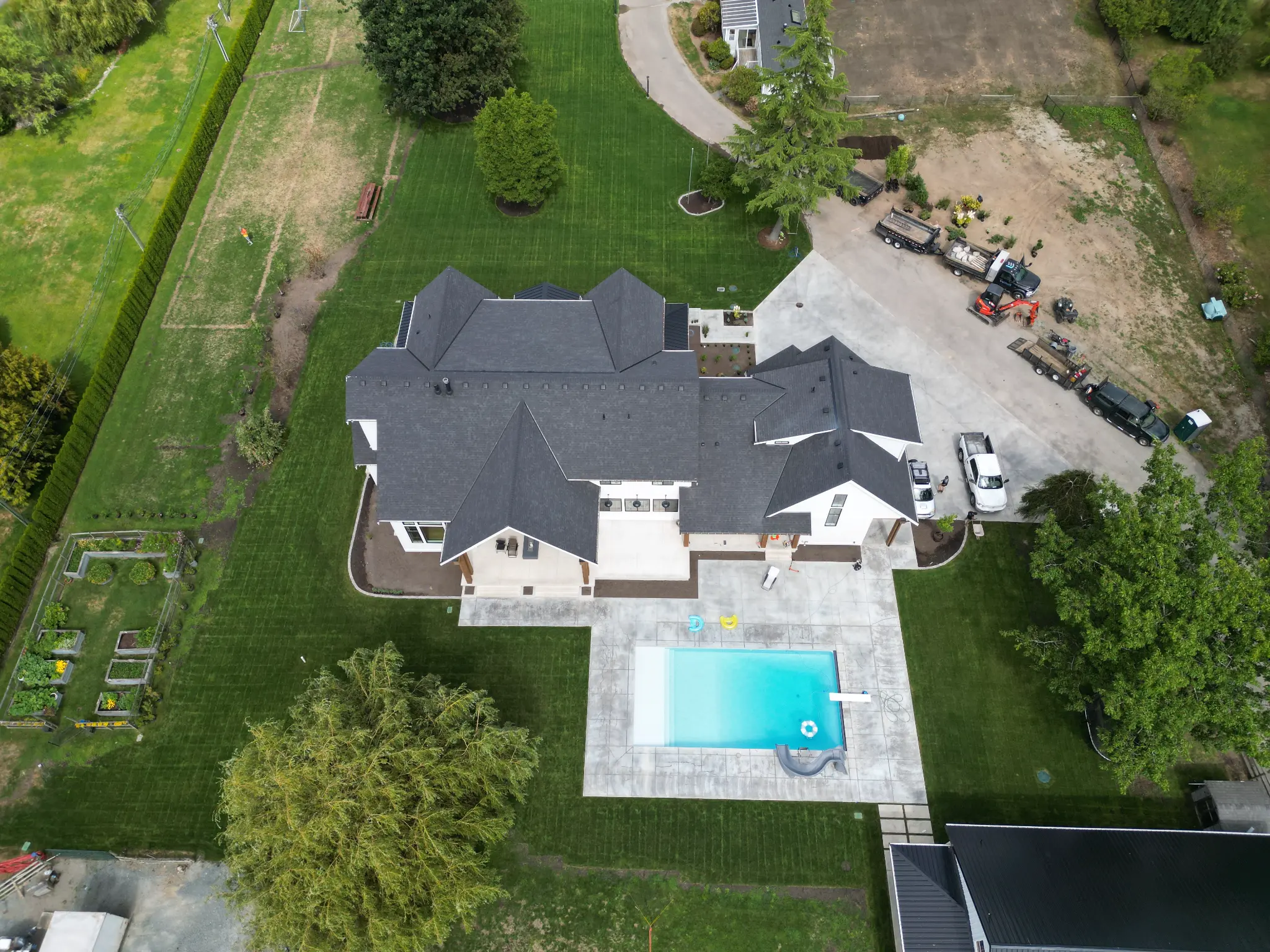 Aerial view of luxury property with pool and manicured grounds