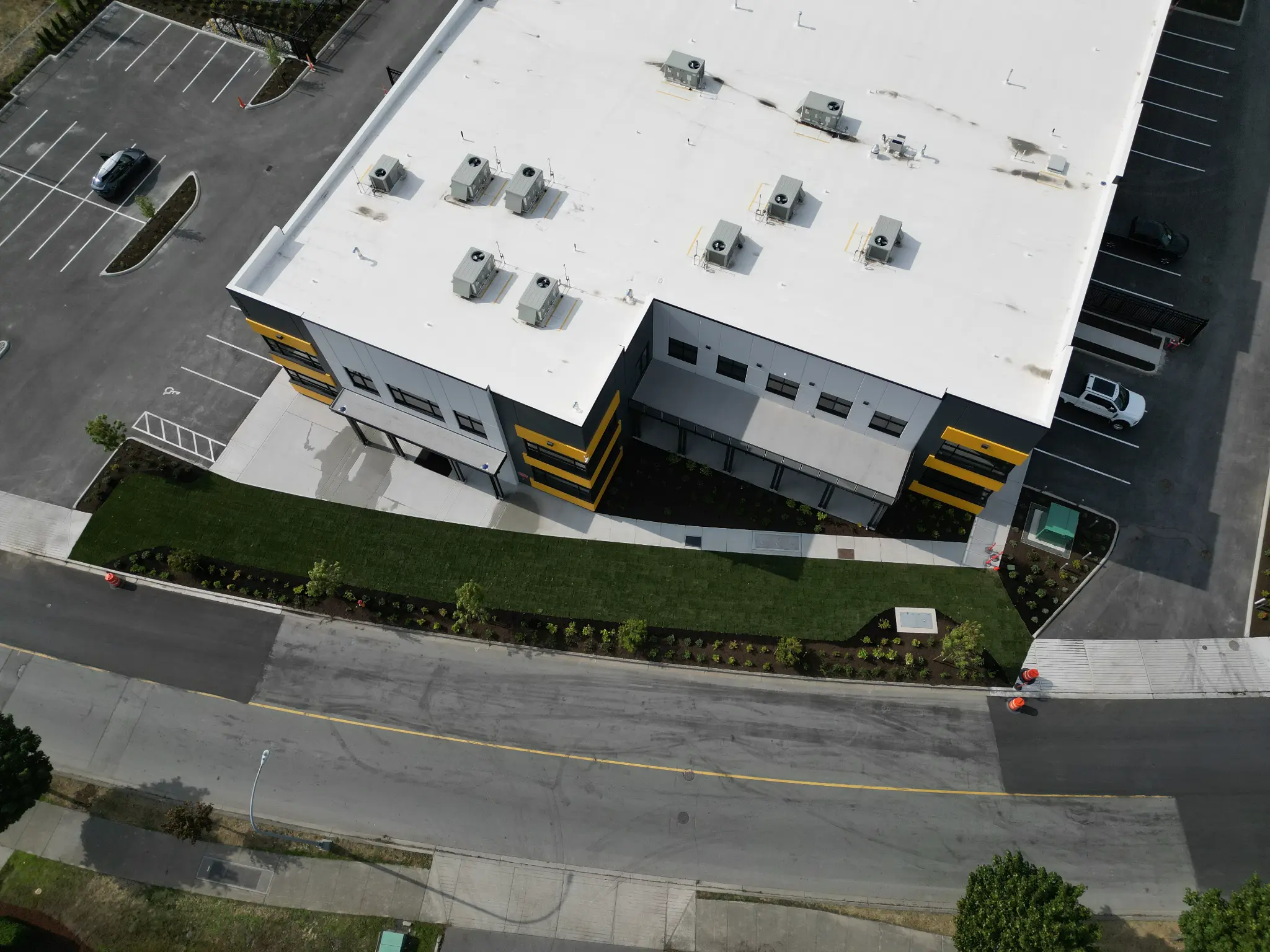 Wide aerial of the completed commercial building and landscaped street frontage