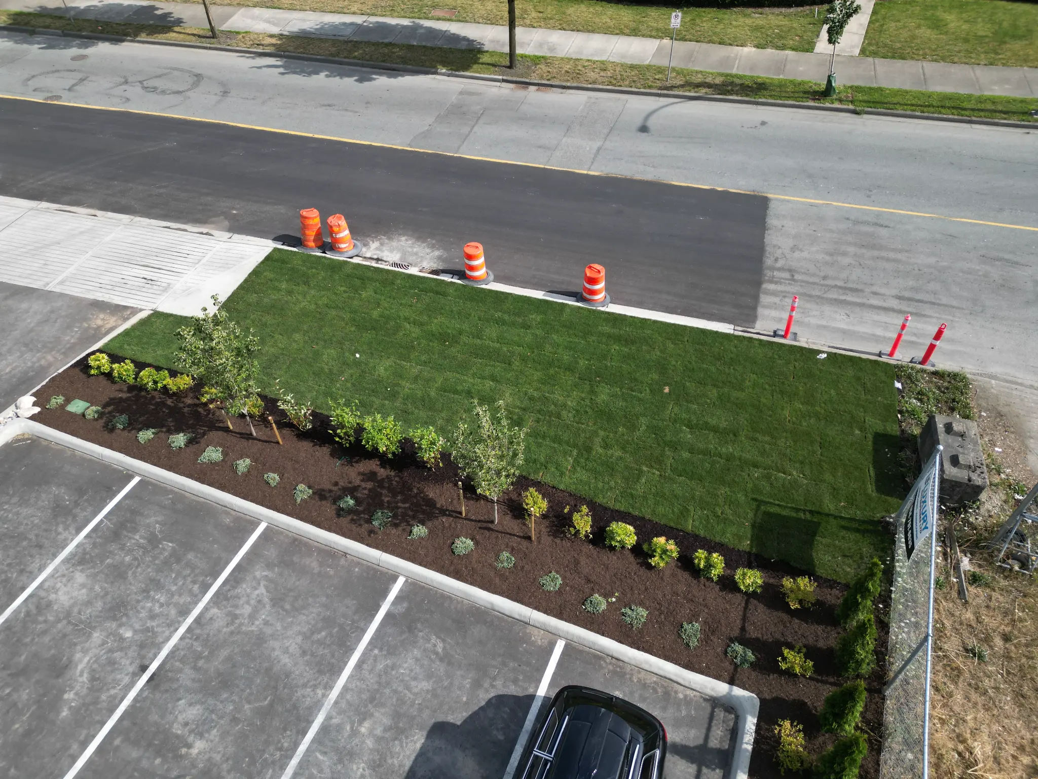 Aerial detail of healthy turf, trees, and irrigated commercial gardens