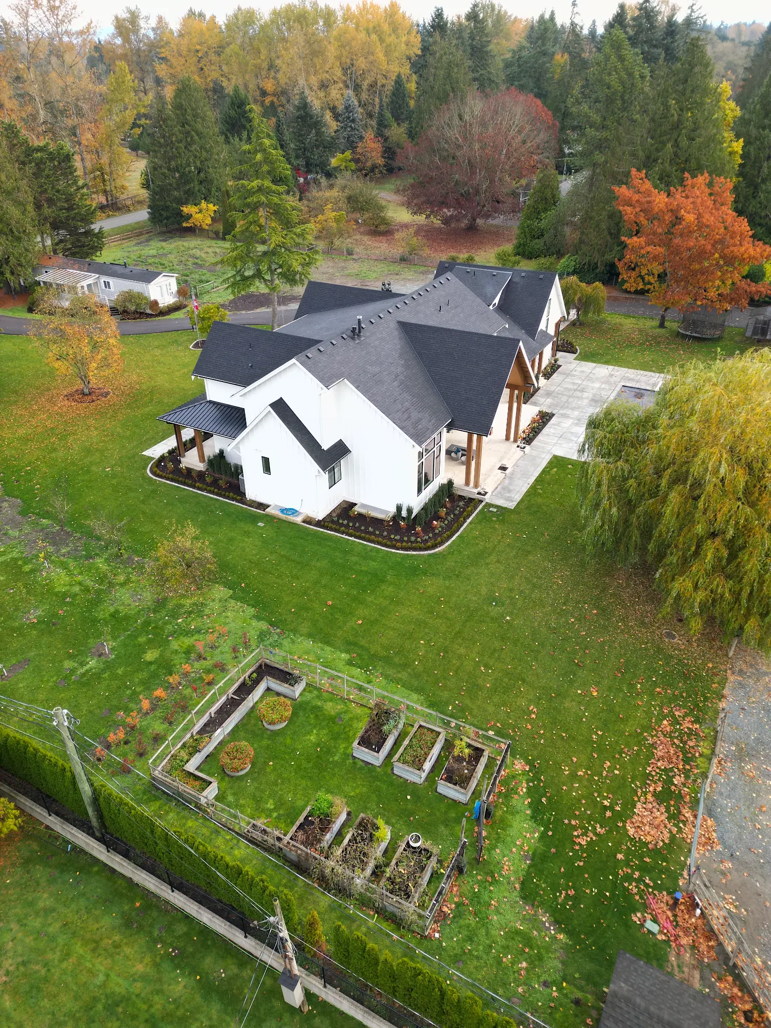 Estate-scale aerial showing lawn installation and surrounding landscape
