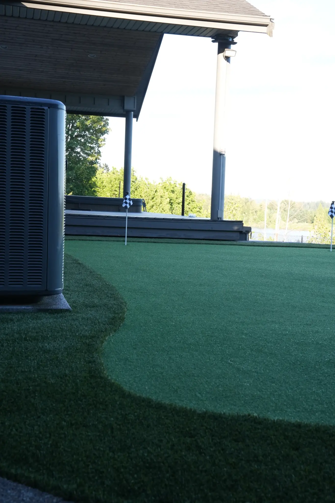 Completed Maple Ridge backyard with artificial turf and low retaining wall
