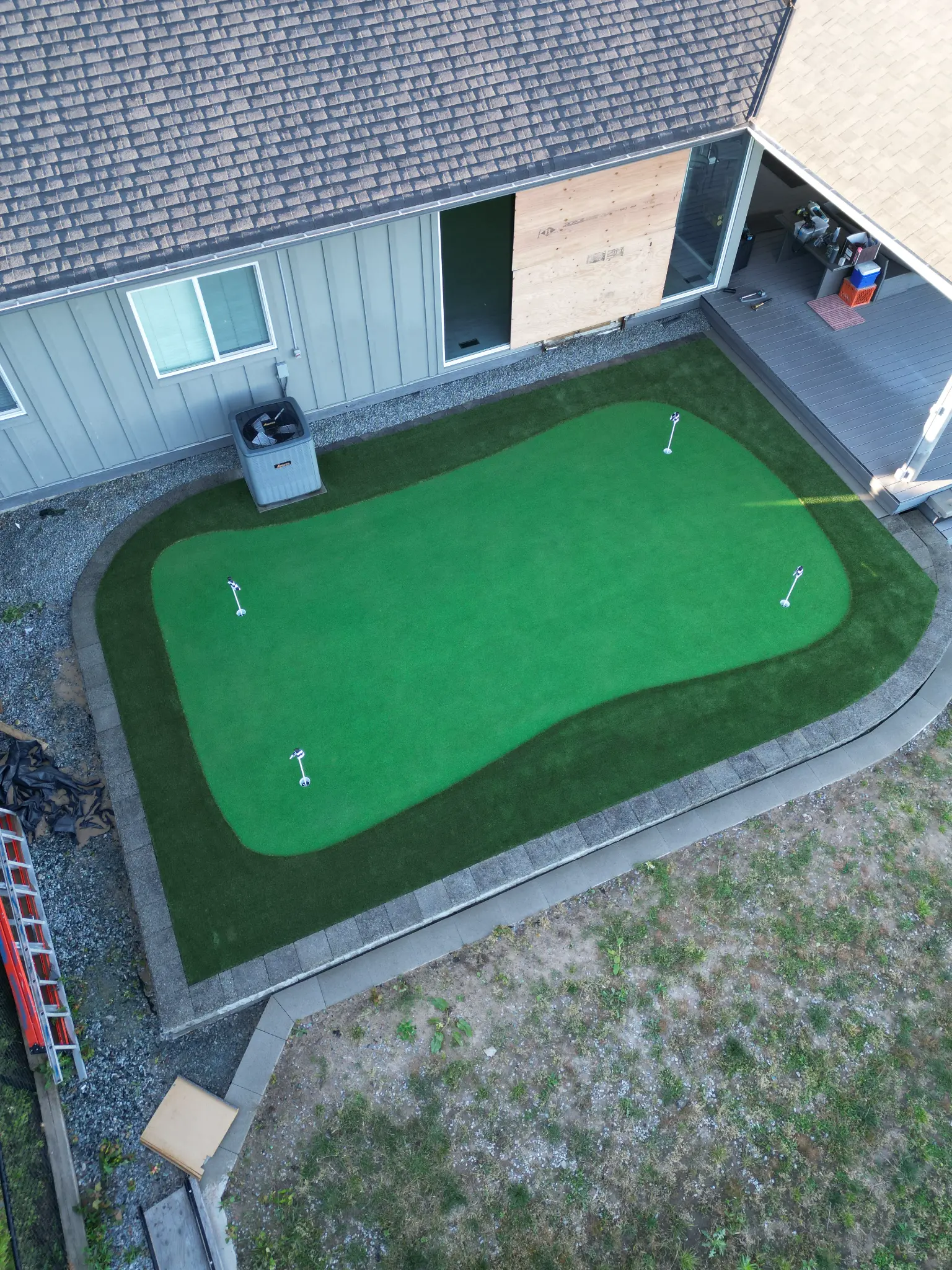 Aerial angle of the artificial turf, retaining wall, and outdoor living space