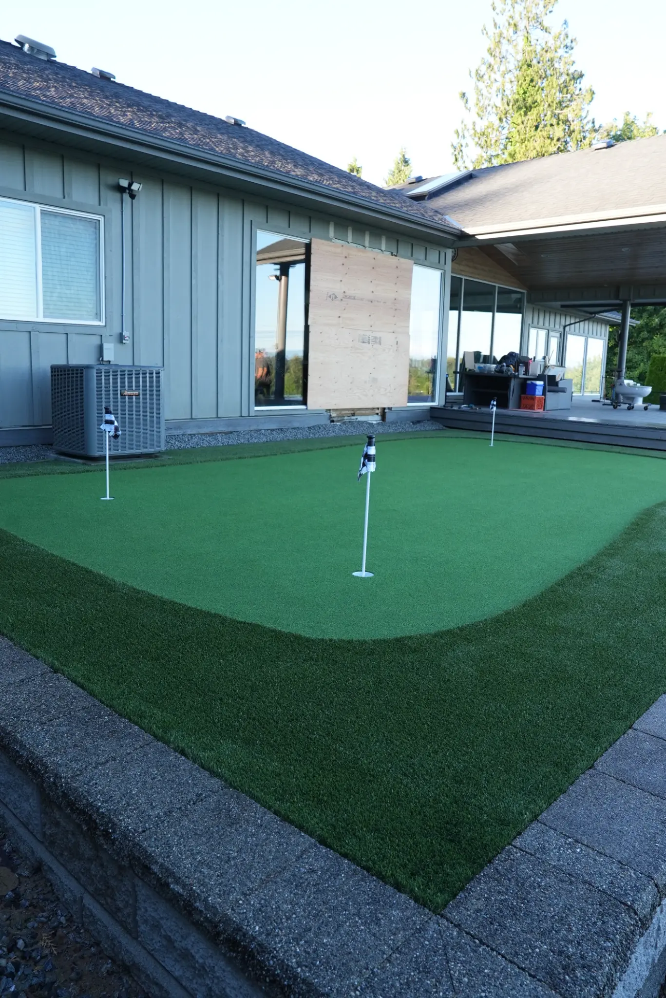 Putting green and artificial turf seen from the lower yard