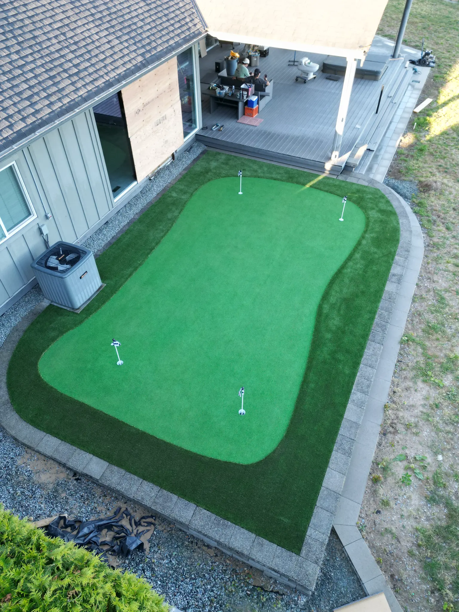 Wide aerial showing the completed backyard layout and neighboring landscape
