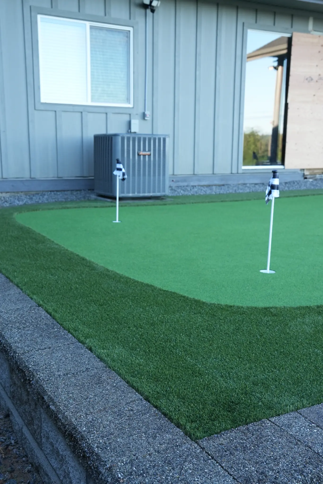Finished artificial-turf area bordered by a masonry retaining wall