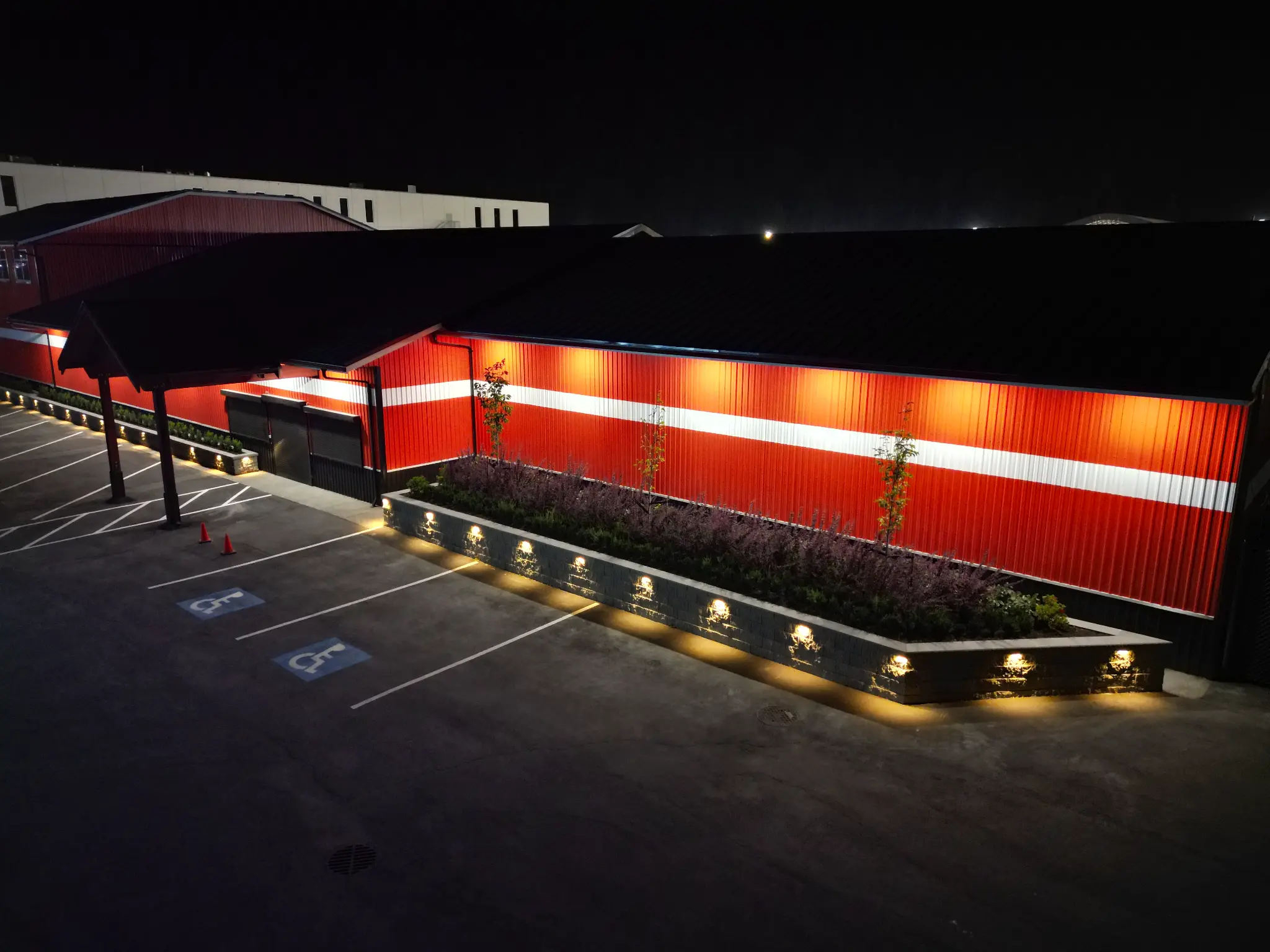 Aerial night view of the North Coast entrance, illuminated planters, and accessible parking