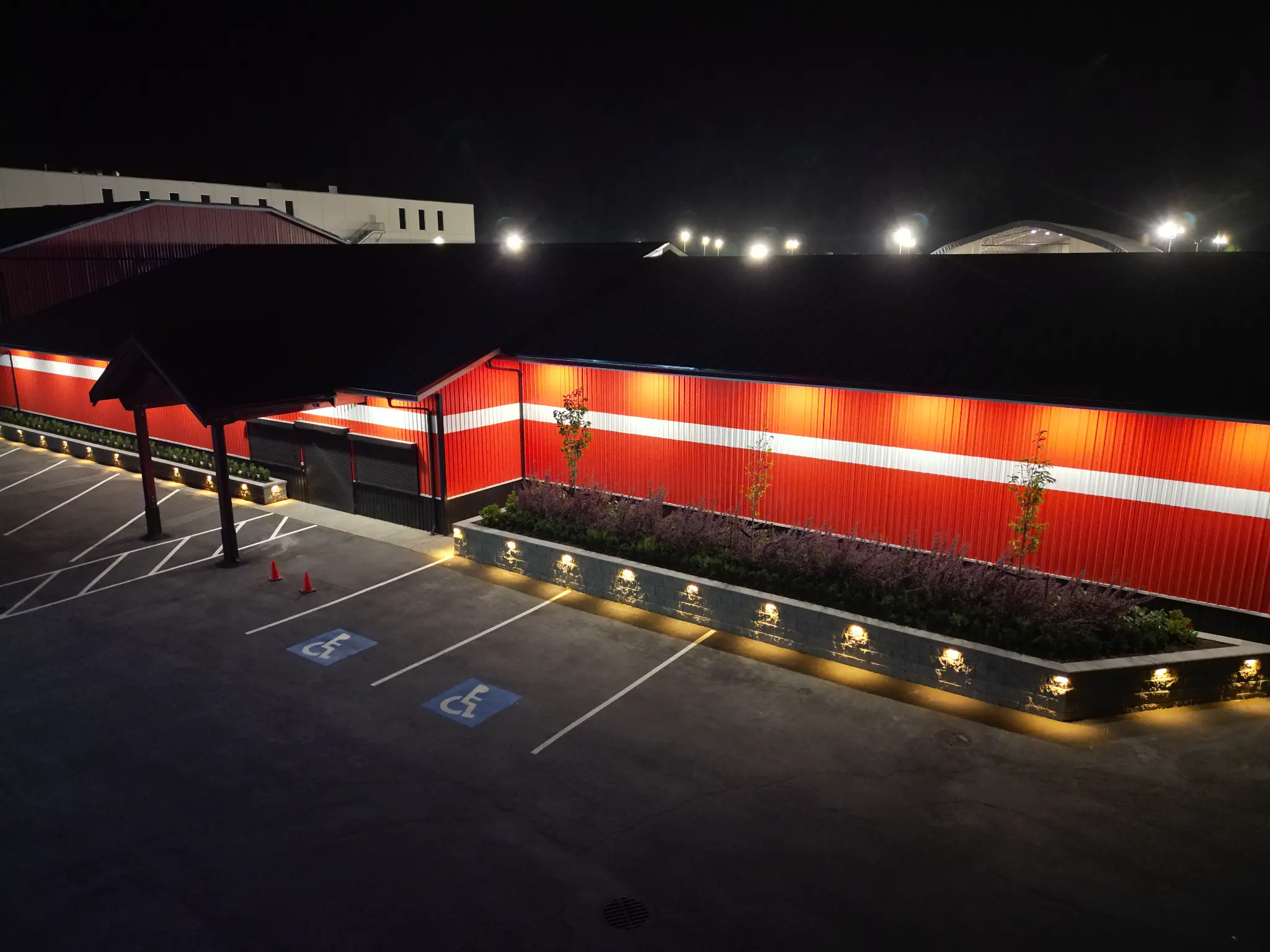Wide aerial view of the North Coast building and illuminated commercial landscaping
