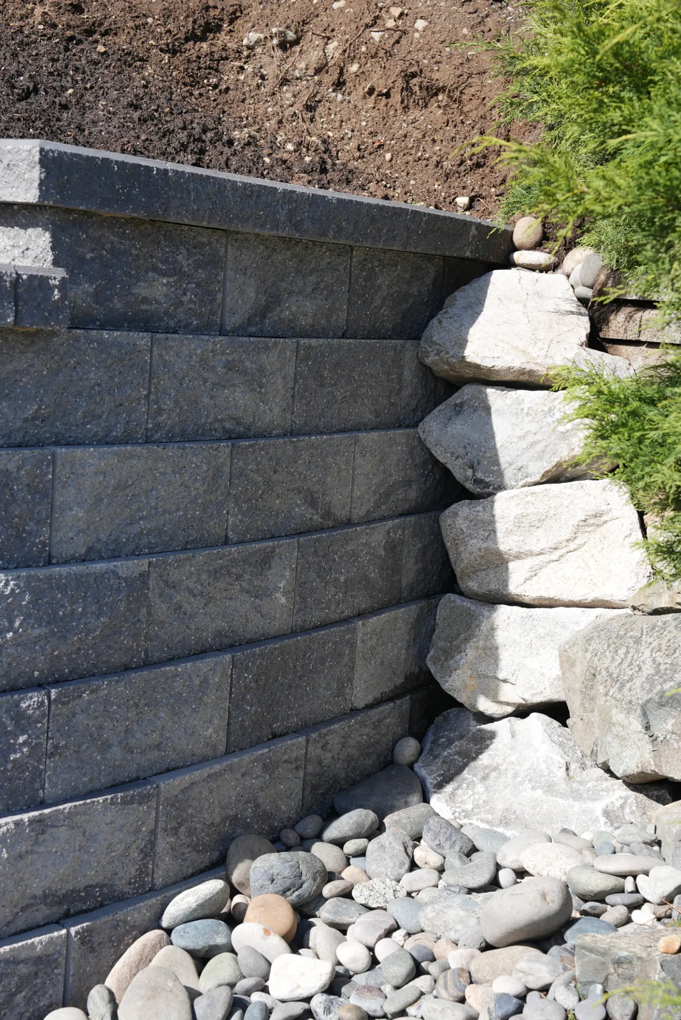 Corner detail of retaining wall showing block pattern and armour stone