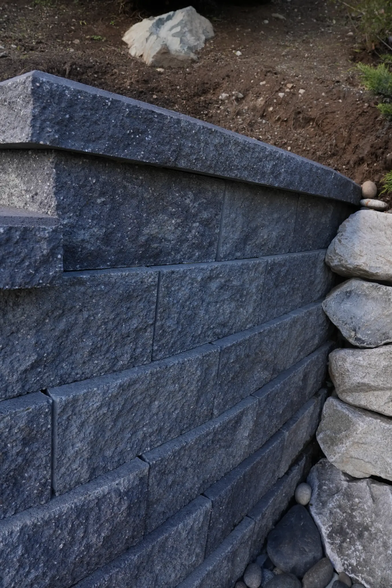 Detail of modular block retaining wall with capping stones