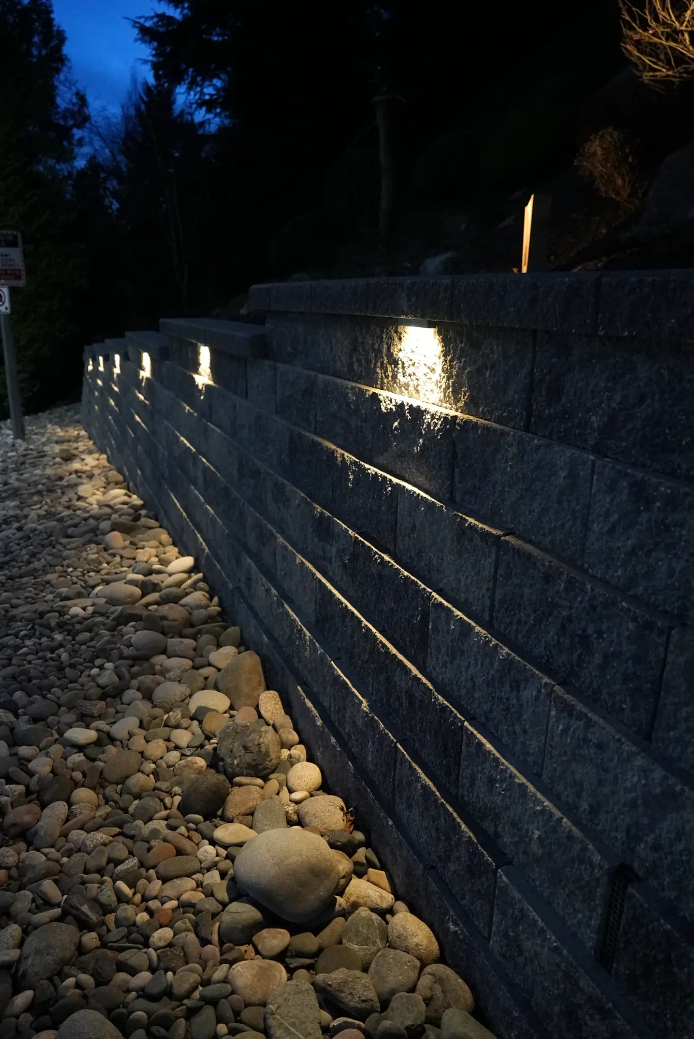 Close-up of retaining wall with integrated cap lights at night