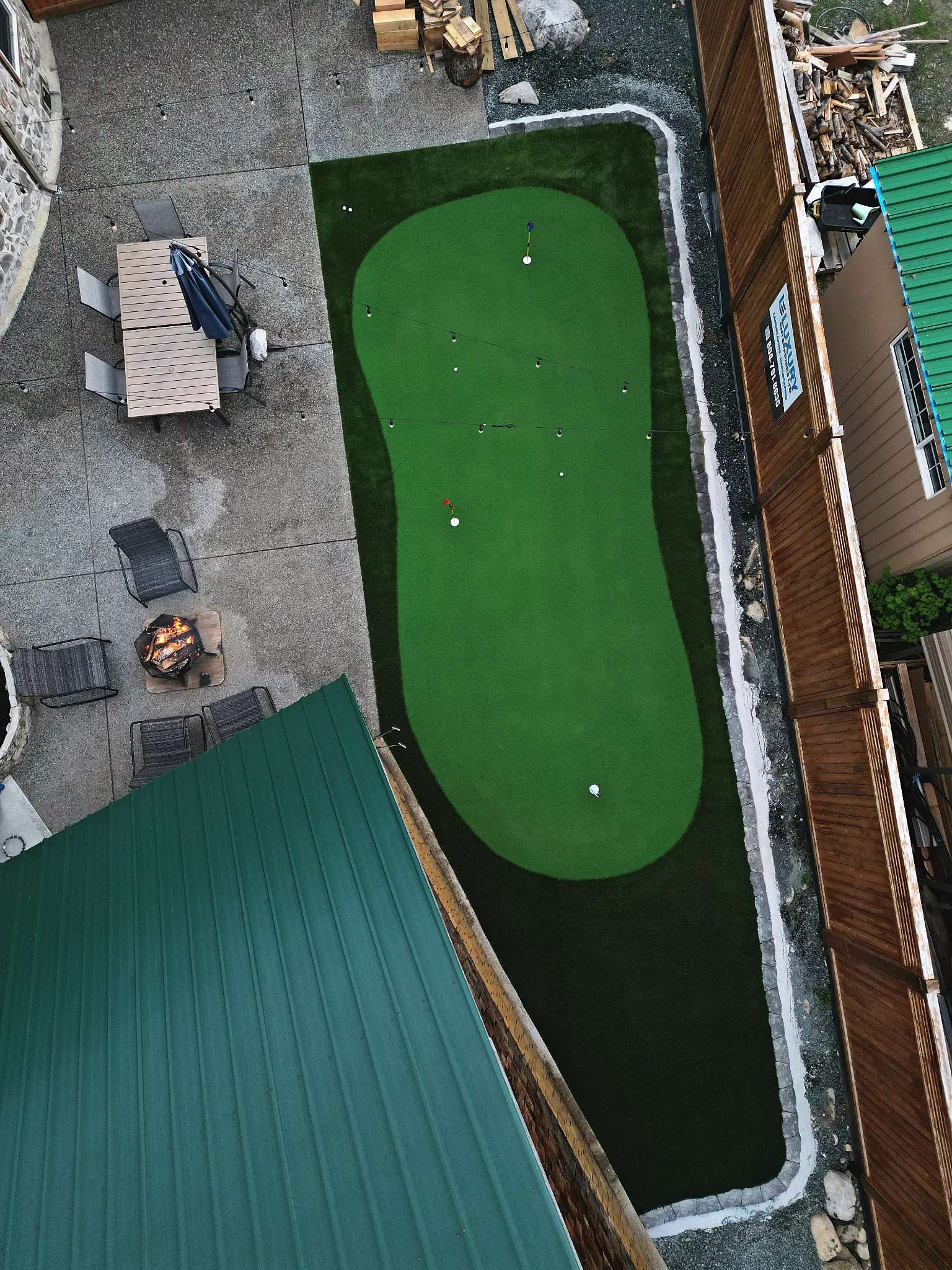 Chilliwack Airbnb property with putting green and landscape lighting at dusk