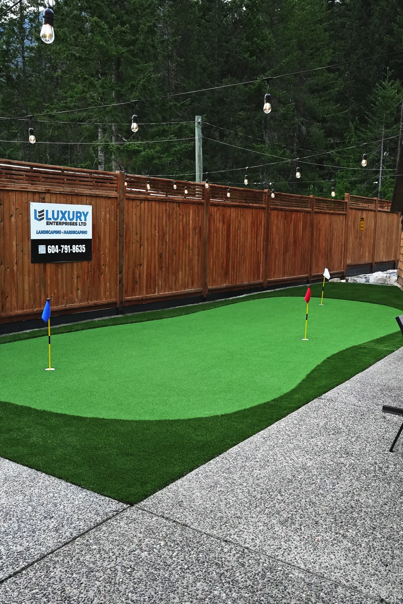 Property detail with lighting and plantings